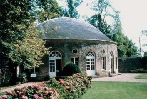 a large stone building with a large window at Château de Bazeilles in Bazeilles