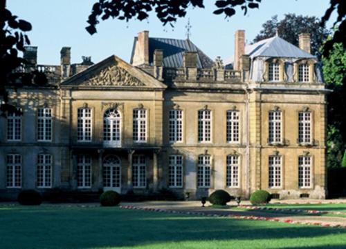 a large brick building with a large yard at Château de Bazeilles in Bazeilles