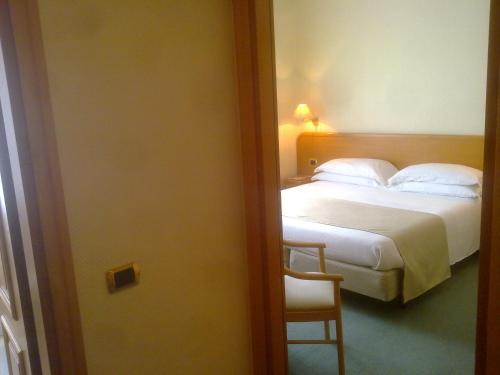 a hotel room with a bed and a chair at Hotel Villa Ida in Ceprano