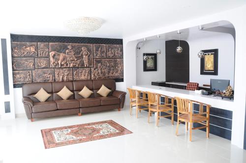 a living room with a couch and a bar at Hotel Ocean Heritage in Kanyakumari