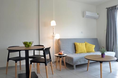 a living room with a couch and two tables at Athena Holiday Homes in Limassol