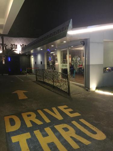 a parking sign in front of a building at night at Jungle City Motel in Chiayi City