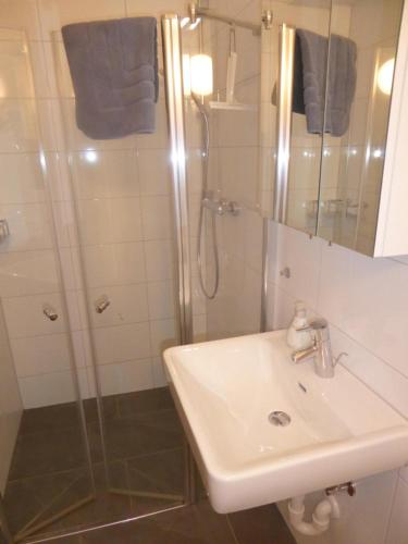 a bathroom with a sink and a shower at Schottar FeWo ST 09 in Dornbirn