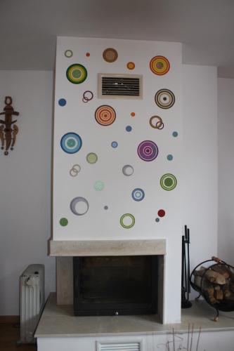 a fireplace with a wall with stickers on it at Studio Moni in Pamporovo