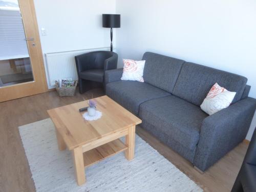 a living room with a couch and a coffee table at Schottar FeWo ST 09 in Dornbirn