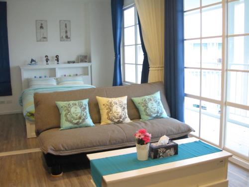 a living room with a couch and a bed at Summer Hua Hin Unit 703 in Hua Hin