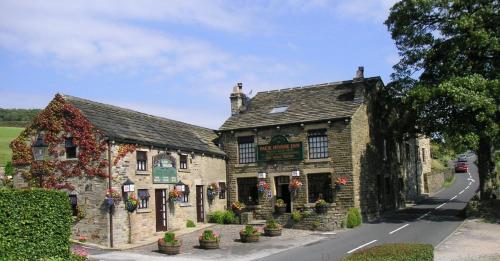 a building on the side of a road at Pack Horse Inn - New Mills in Mellor