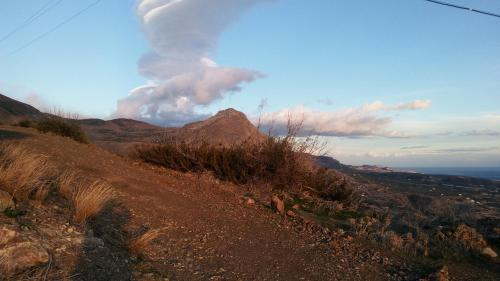 a view of a mountain from a dirt road at Chouzourakis Studios in Keratokampos