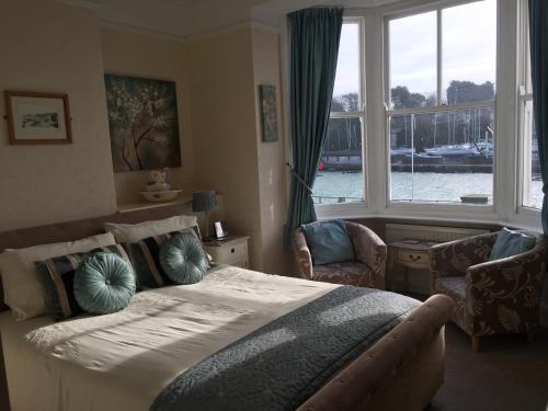 a bedroom with a bed and a large window at The Chatsworth in Weymouth