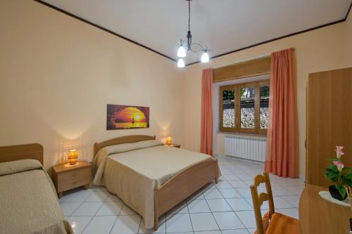 a bedroom with a bed and a window at Casa Generosa in Agerola