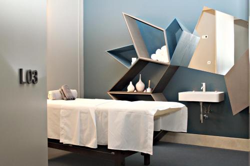a bathroom with a white table and a sink at Azoris Royal Garden – Leisure & Conference Hotel in Ponta Delgada