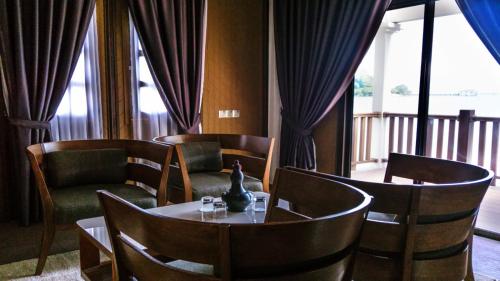a room with a table and chairs and a window at Casuarina Pangkor in Pangkor