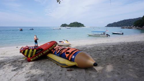 a person standing on a beach with a group of objects at Casuarina Pangkor in Pangkor