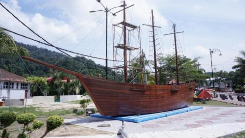 a large wooden boat on display in a park at Casuarina Pangkor in Pangkor