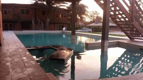 an empty swimming pool in a house with a building at Beautiful House in Heart of Pachacamac in Pachacamac