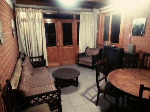 a living room with a couch and chairs and tables at Beautiful House in Heart of Pachacamac in Pachacamac