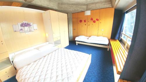 a small room with two beds and a window at Apartment Ski Marilleva 1400 in Marilleva