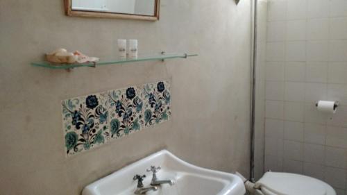 a bathroom with a sink and a toilet at Hostería Bello Horizonte in La Paz