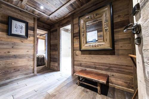 a room with a wooden wall with a bench in it at Le Chalet Blanc in Megève
