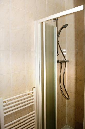 a shower with a glass door in a bathroom at Almond Tree Hotel in Bicester