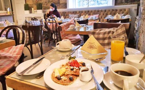 a table with a plate of food and a cup of coffee at Fitzwilliam Townhouse in Dublin