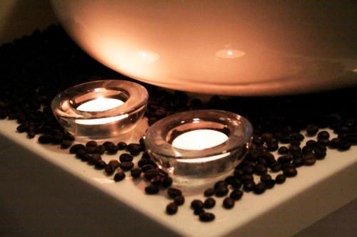 two candles sitting on top of a table with chocolate chips at Hotel Ameliówka in Masłów