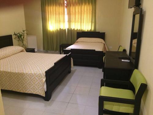 Hotel Santander SD tesisinde bir odada yatak veya yataklar