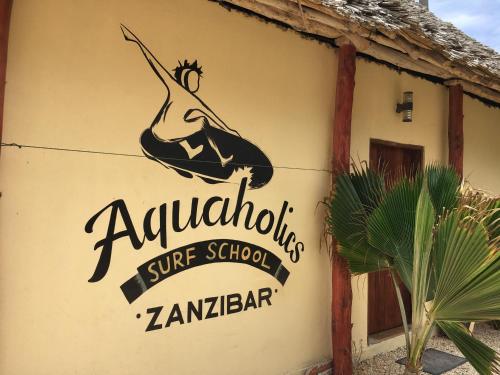 a sign on the side of a school building at The Sands Beach Resort in Bwejuu