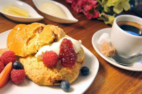 a plate with a pastry with berries and a cup of coffee at The Gateway Lodge in Donegal