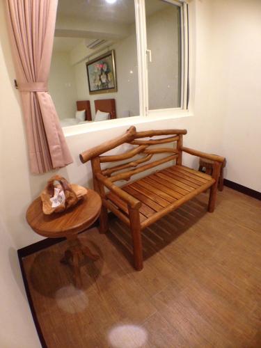 a bedroom with a bed and a table and a window at Long Zhi Yue Hotel in Nangan