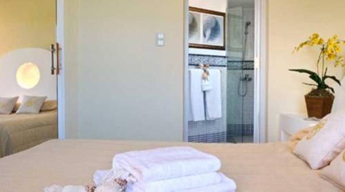 a bedroom with a bed with towels on it at Lifestyle Crown Residence Suites in San Felipe de Puerto Plata