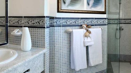 a bathroom with a sink and a towel at Lifestyle Crown Residence Suites in San Felipe de Puerto Plata