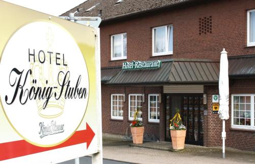 a sign for a hotel in front of a building at Hotel König-Stuben in Bispingen