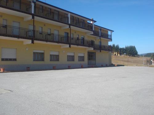 a large building with balconies on the side of it at Hotel Grandinetti in Parenti