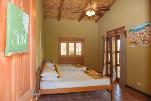 A bed or beds in a room at Apoyo Lodge
