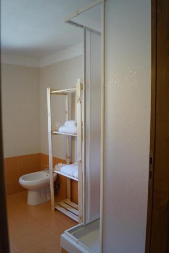 a bathroom with a toilet and a glass door at Bonjour Bonheur in Avellino
