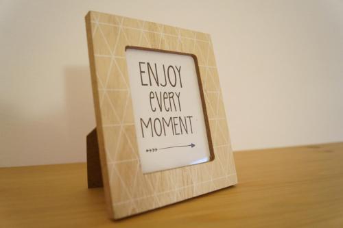 a book with a sign that reads enjoy every moment at Bonjour Bonheur in Avellino
