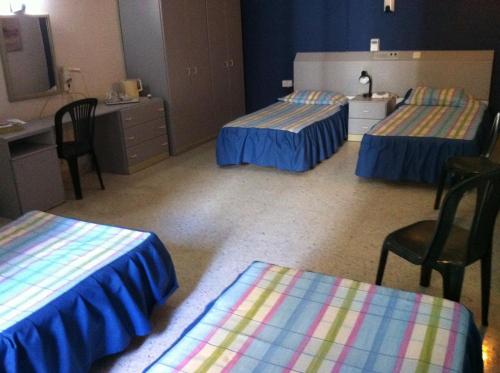 a hospital room with three beds and a sink at Roma Hotel in Sliema