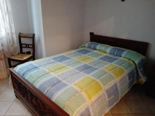 a bed in a bedroom with a chair next to it at Hotel Ponte San Vittorino in Assisi
