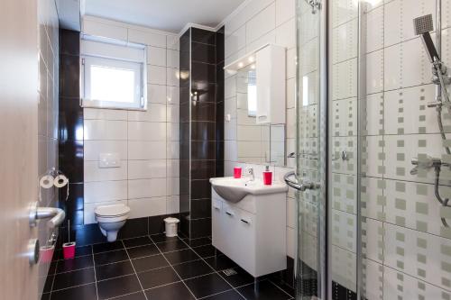 a bathroom with a sink and a toilet at Knezovic Apartments in Podstrana