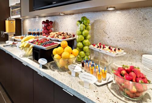 a buffet with fruit and drinks on a counter at Wyndham Edmonton Hotel and Conference Centre in Edmonton