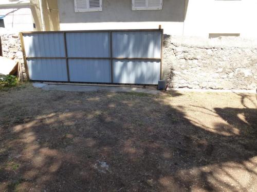 a large metal gate in front of a house at Apartment Marija in Tisno