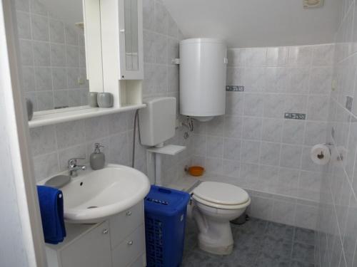 a bathroom with a toilet and a sink at Apartment Marija in Tisno