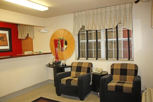 a waiting room with two chairs and a mirror at Extended Stay America Suites - Huntsville - US Space and Rocket Center in Huntsville