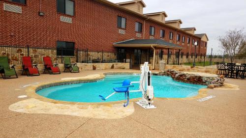 a pool with a water slide in front of a building at Velkommen Inn in Clifton