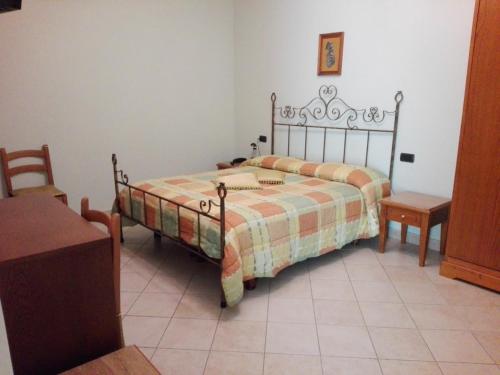 a bedroom with a bed and a table and a chair at Hotel Ponte San Vittorino in Assisi