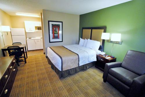 a hotel room with a bed and a chair at Extended Stay America Select Suites - Chattanooga - Airport in Chattanooga