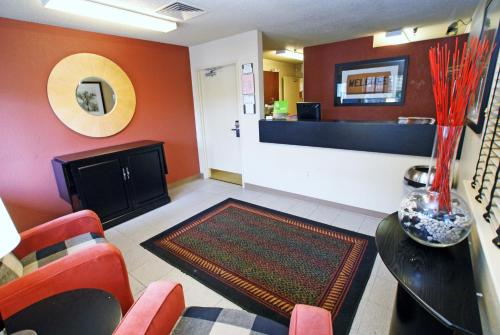 a waiting room with orange walls and red chairs at Extended Stay America Select Suites - Chattanooga - Airport in Chattanooga