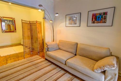 a living room with a couch and a shower at Braga Sarmiento Apartment in Braga