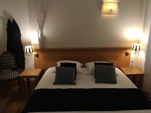 a bedroom with a large bed with two pillows at Chambres D'Hotes Rekko in Maastricht